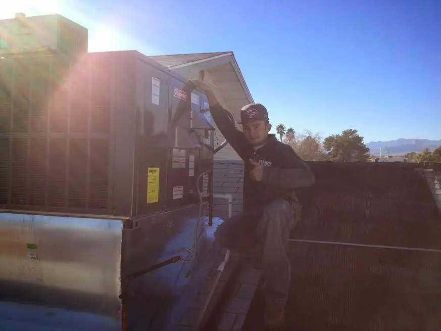 HVAC technician performing Air Duct Repair on a rooftop unit in West Whittier-Los Nietos